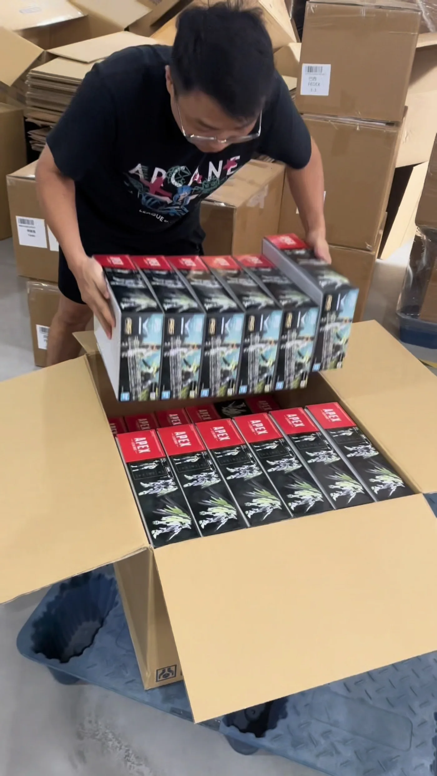 Boxed goods being packed into a shipping carton